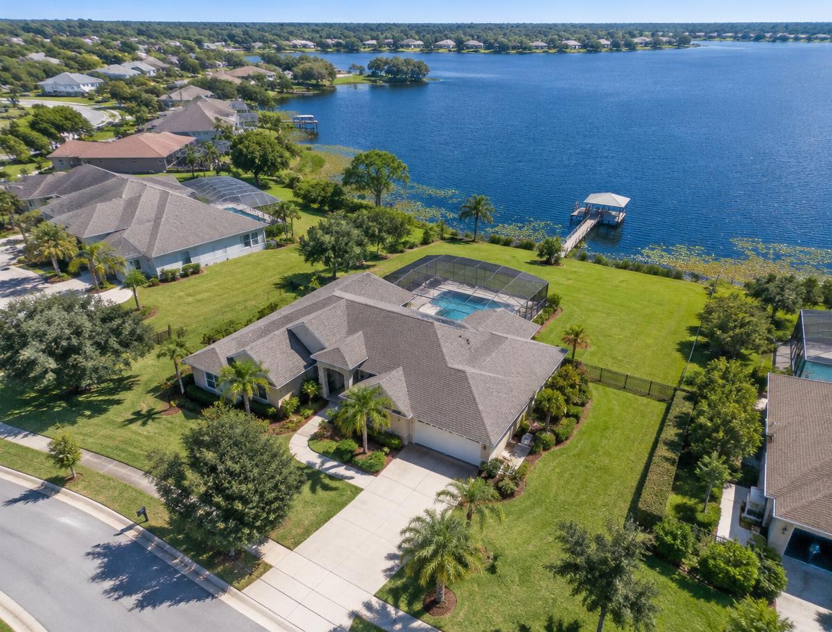 Aerial view of a lakefront Florida home with pool and dock