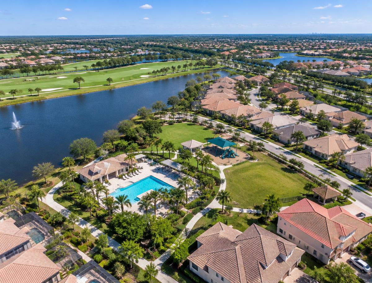 Aerial view of a Florida neighborhood with golf course, lake and community pool